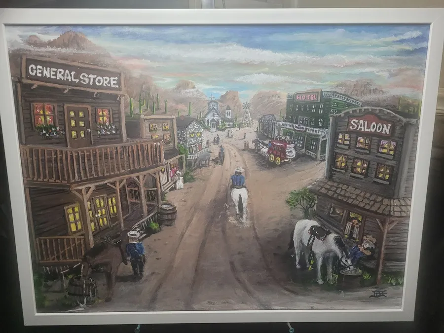 Western town street with a general store, hotel, saloon, riders on horseback and a stagecoach beneath a cloudy desert sky.